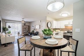 Phoenix apartment for rent - A dining room with a table set for two and a couch at Sterling Point Apartment Homes, Arizona