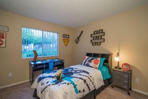 Phoenix apartment for rent - A bedroom with a bed, a desk, and a window at Sterling Point Apartment Homes, Arizona, 85042
