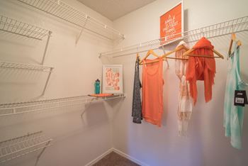 A white wall with clothes hanging on it.