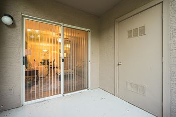 A room with a sliding door and a white door.