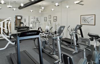 A gym with treadmills and other exercise equipment