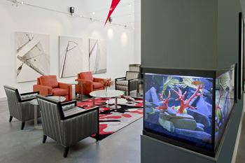 A large aquarium in a room with chairs and tables