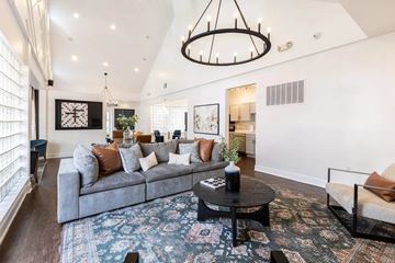 Cary apartment for rent - A living room with a grey sofa, a black coffee table, and a rug with a pattern.