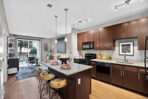 Washington apartment for rent - A modern kitchen with brown cabinets and a large island.