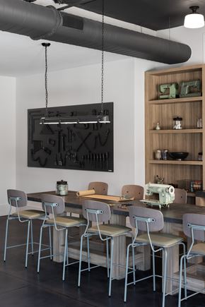 Tampa apartment for rent - A modern kitchen with a long table and chairs.
