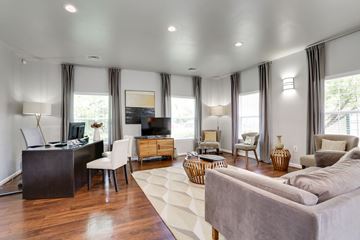 Arlington apartment for rent - A living room with a grey couch and a wooden floor.