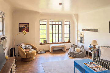 Salt Lake City apartment for rent - A living room with a yellow chair and a blue table.