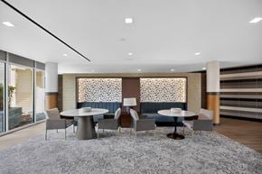 Washington apartment for rent - A modern dining room with a grey rug and a round table with chairs.