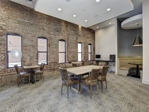 Baltimore apartment for rent - a conference room with a large table and chairs and a brick wall at The Gunther, Maryland, 21224
