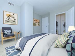 Silver Spring apartment for rent - a bedroom with a bed and a chair in a room at The Gramax, Silver Spring, MD