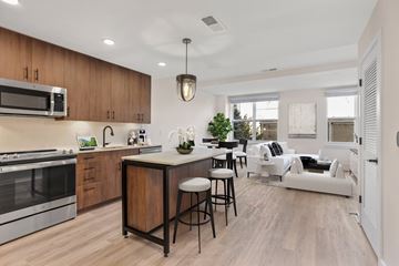 Washington apartment for rent - A modern kitchen with wooden cabinets and a large island.