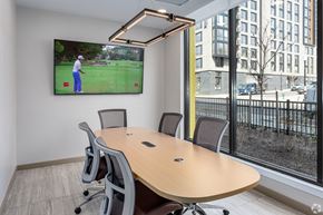 Washington apartment for rent - a conference room with a tv and a table with chairs