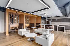 Washington apartment for rent - a lounge area with couches tables and chairs and a kitchen