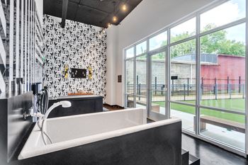 A bathroom with a tub and a large window
