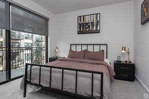 Washington apartment for rent - a bedroom with a bed and a large window