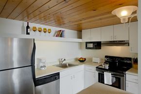 Baltimore apartment for rent - a kitchen with white cabinets and a stainless steel refrigerator at Tindeco Wharf, Baltimore