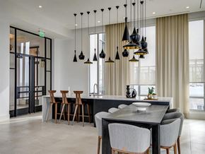 Tysons apartment for rent - a kitchen with a long counter and a table at The Boro, Tysons