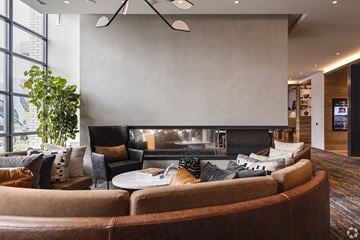 Washington apartment for rent - A living room with a brown couch and a fireplace.