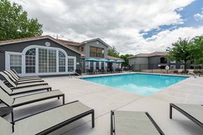 Albuquerque apartment for rent - A pool area with sun loungers and a building in the background at West Park Apartments, Albuquerque
