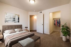 Albuquerque apartment for rent - A bedroom with a bed, a bench, and a plant at West Park Apartments, Albuquerque, 87114
