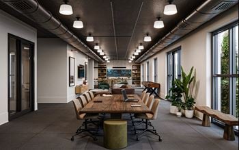 A large conference room with tables and chairs and large windows