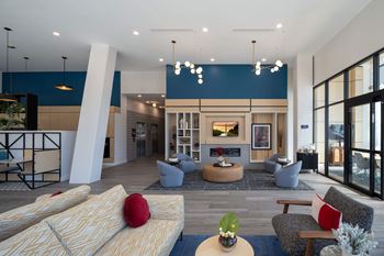 A modern living room with a fireplace and a large window.