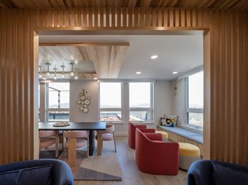 A modern living room with a dining table and chairs.