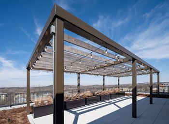 A modern pergola with wooden slats and metal frame.