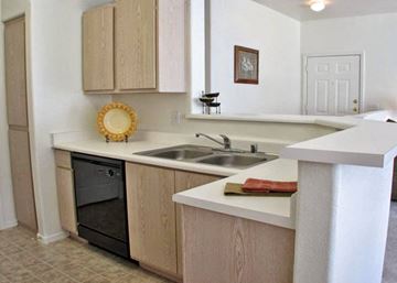 Mesa apartment for rent - A kitchen with a white counter top and a black oven.