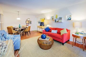 Raleigh apartment for rent - A living room with a red couch and a wooden coffee table.