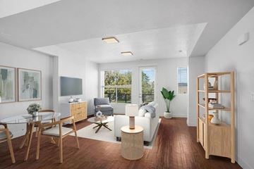 Lehi apartment for rent - A modern living room with a glass table and chairs, a sofa, and a TV.