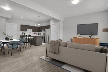 Millcreek apartment for rent - A modern living room with a grey sofa and a television.