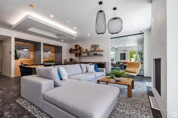 Salt Lake City apartment for rent - A modern living room with a grey sofa and a wooden coffee table.