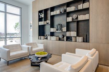 Baltimore apartment for rent - A modern living room with white furniture and a black coffee table.