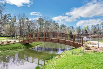 A bridge over a pond in a park