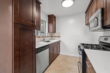 Hollywood multi-family for rent - A kitchen with brown cabinets and a black stove top.
