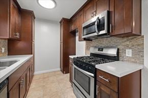 Hollywood multi-family for rent - A kitchen with brown cabinets and a stove top oven.