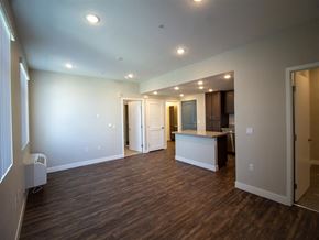 San Bernardino multi-family for rent - living room with a kitchen in the background at Loma Villas Apartments, San Bernardino, 92408