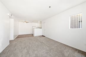 Diamond Bar apartment for rent - A spacious, empty room with a carpeted floor and a window with blinds. at Whispering Fountains Diamond Bar, Diamond Bar, CA 91765
