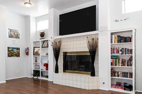 Lakewood apartment for rent - A living room with a fireplace and bookshelves. at Whispering Fountains Lakewood, California, 90805