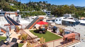 Hollywood multi-family for rent - Rooftop terrace with artificial grass and red umbrella at Joro Properties Apartments, Hollywood, CA