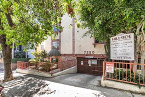 Hollywood multi-family for rent - Apartment entrance with property sign and gated access at Joro Properties Apartments, California