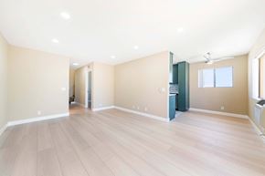 Hollywood multi-family for rent - Open living room with kitchen and light wood floors at Joro Properties Apartments, Hollywood, CA