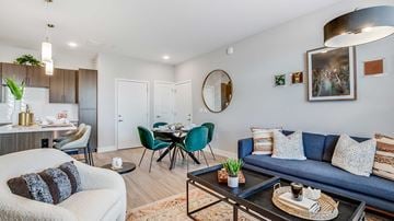 Centennial apartment for rent - A living room with a blue couch and a coffee table.