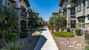 Phoenix apartment for rent - a walkway between two apartment buildings with trees and landscaping