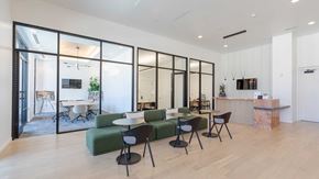 Aurora apartment for rent - Modern coworking lounge and private meeting rooms with contemporary seating and workspace design at Tempo at Nine Mile apartments.
