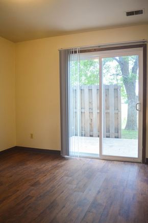 Fort Collins apartment for rent - an empty living room with a sliding glass door to a yard
