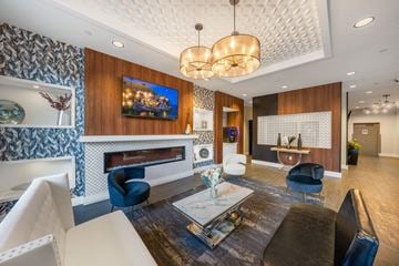 Minneapolis multi-family for rent - a living room with blue and white furniture and a fireplace