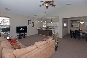 Richland multi-family for rent - A living room with a couch, television, and a ceiling fan.