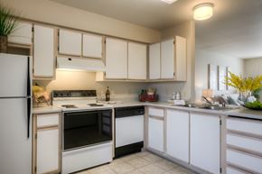 Richland multi-family for rent - A kitchen with white appliances and cabinets.
